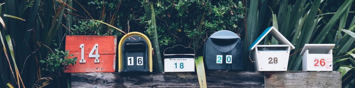 six assorted-color mail boxes